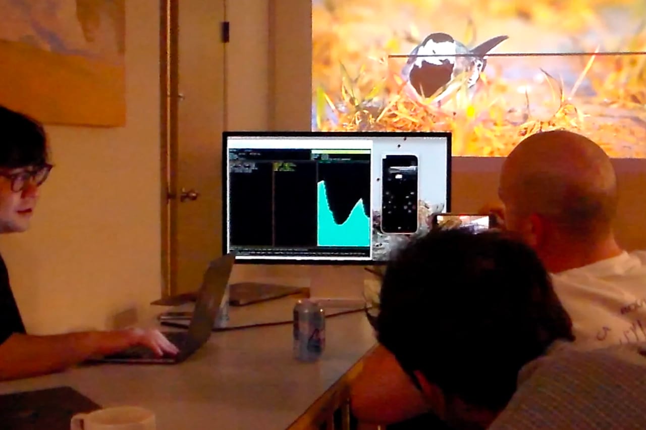 Attendees gathered around a projected data visualization.