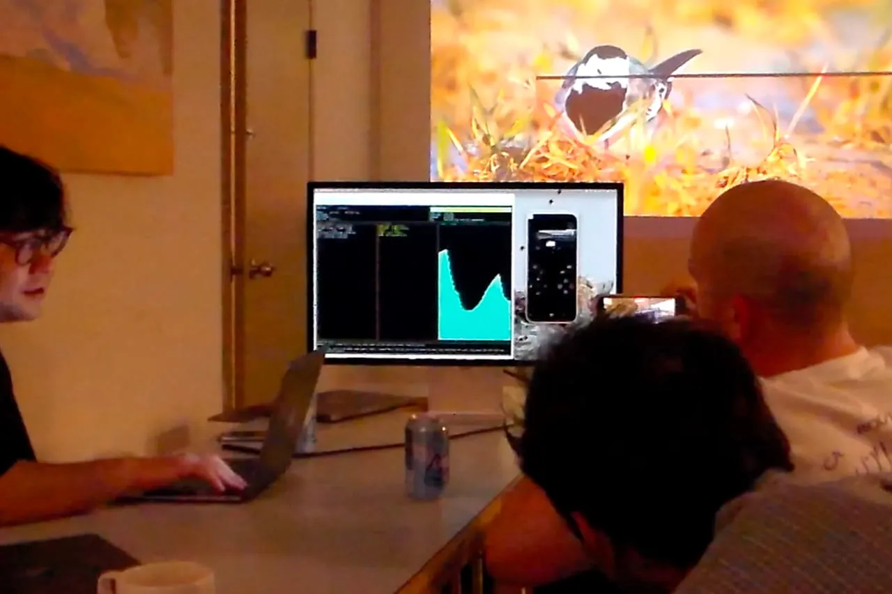 Attendees gathered around a projected data visualization.