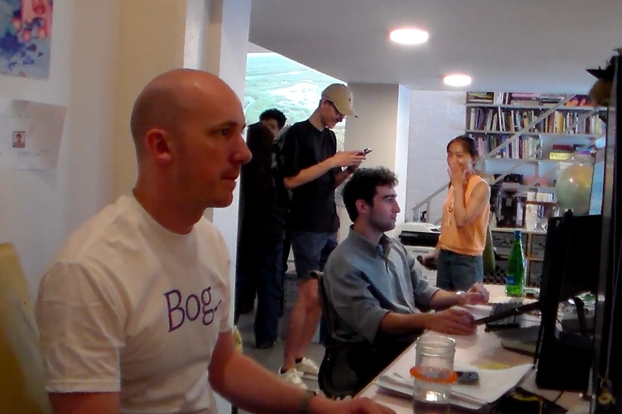 Participants gathered around computers in the office.