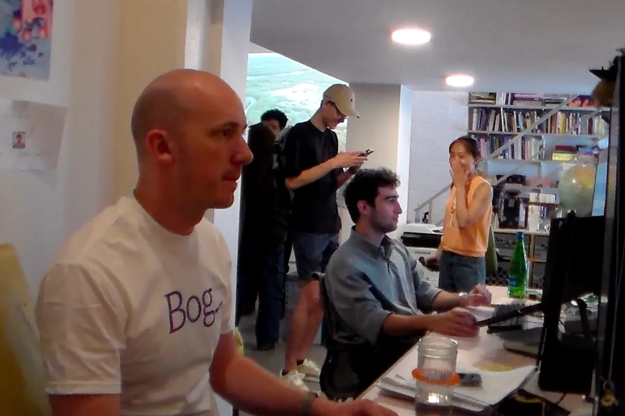 Participants gathered around computers in the office.