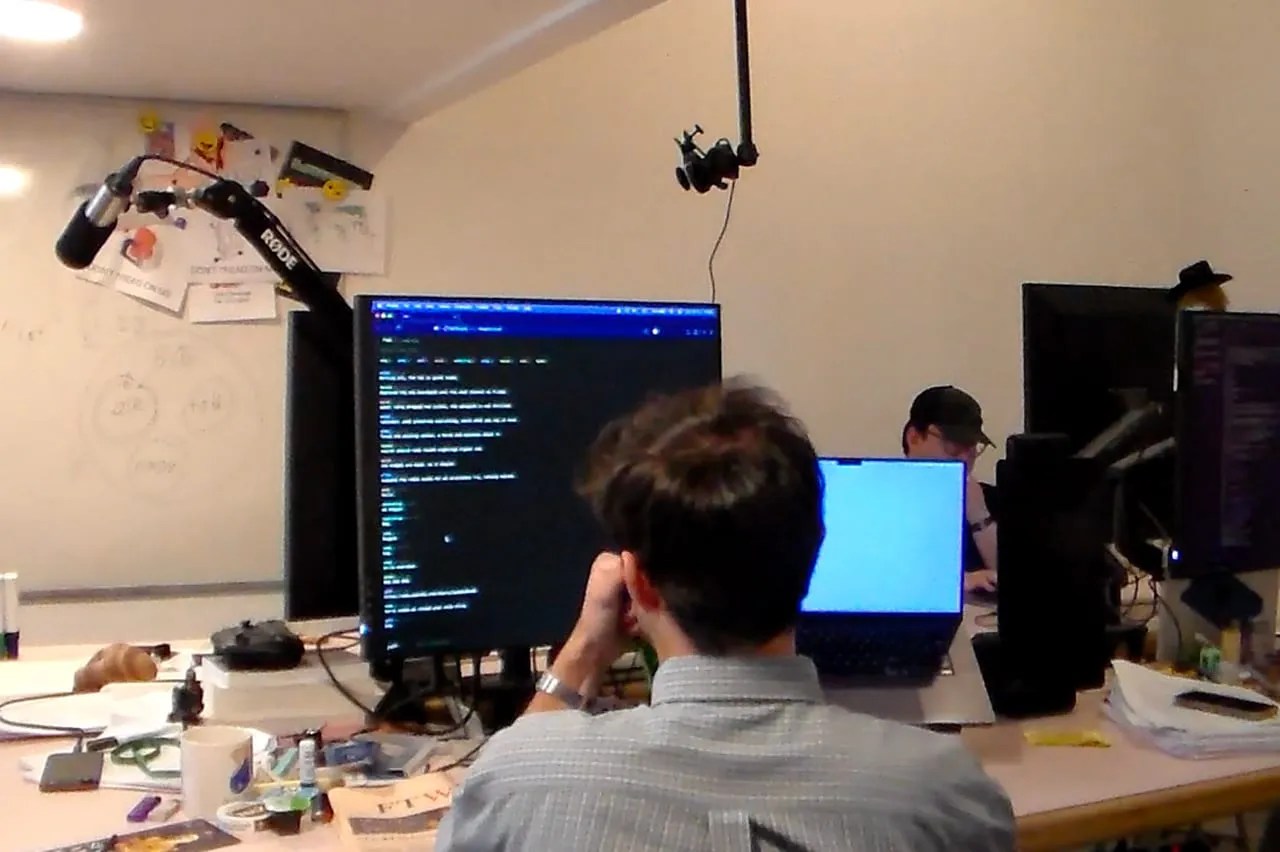 A participant coding at a dual-monitor workstation.