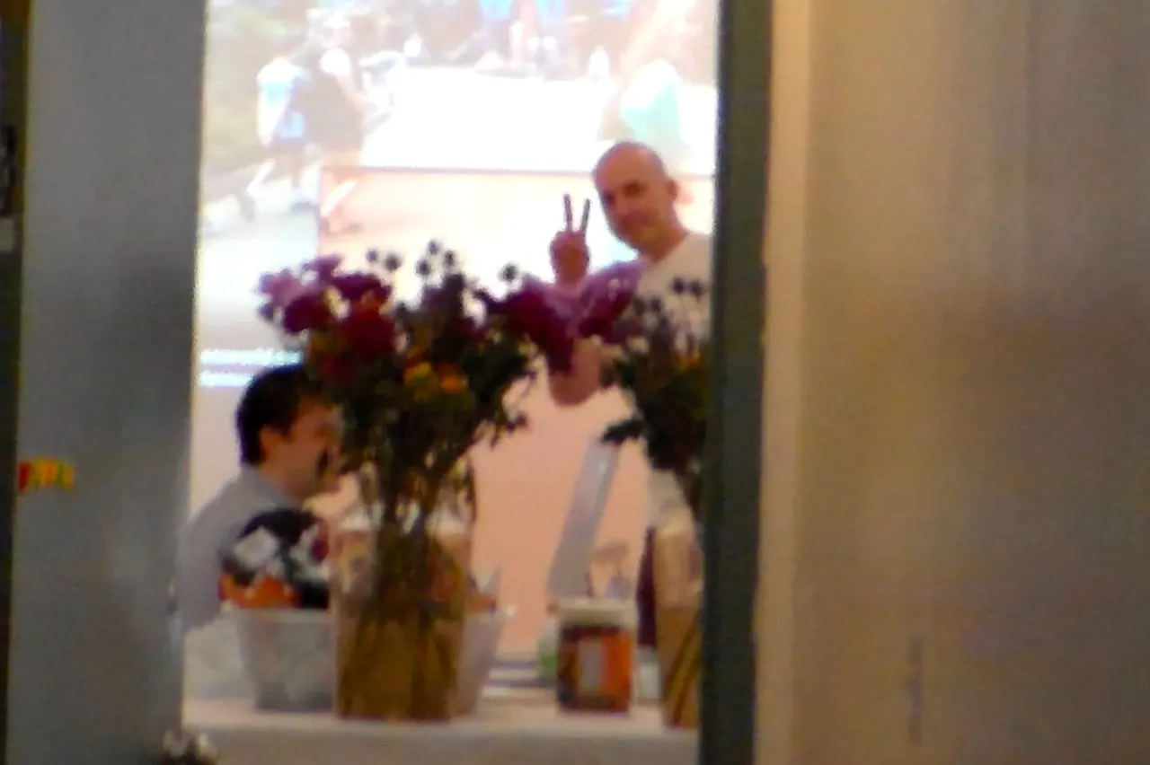 Flowers in the foreground while participants gather behind them.